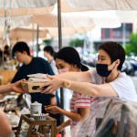 從攤販?zhǔn)种薪舆^(guò)最適合午後享用的輕食，攤販同時(shí)將心意以雙手一同遞上，彼此的這份互動(dòng)是盛夏美好的一景。